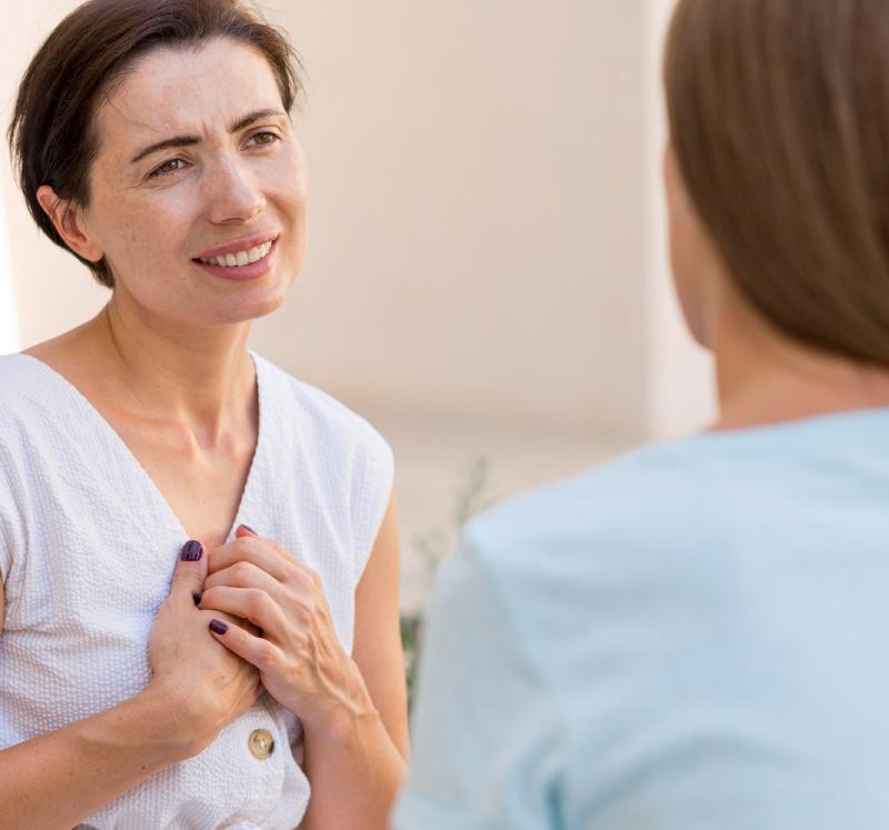 Two Women Communicating With Each Other By Using Sign Language